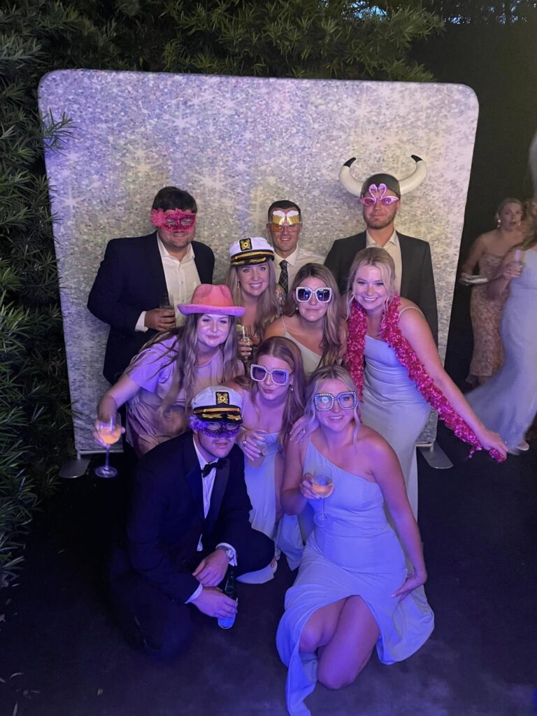 party guests posing with photo booth props