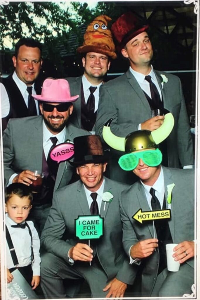 groomsmen posing with photo booth props
