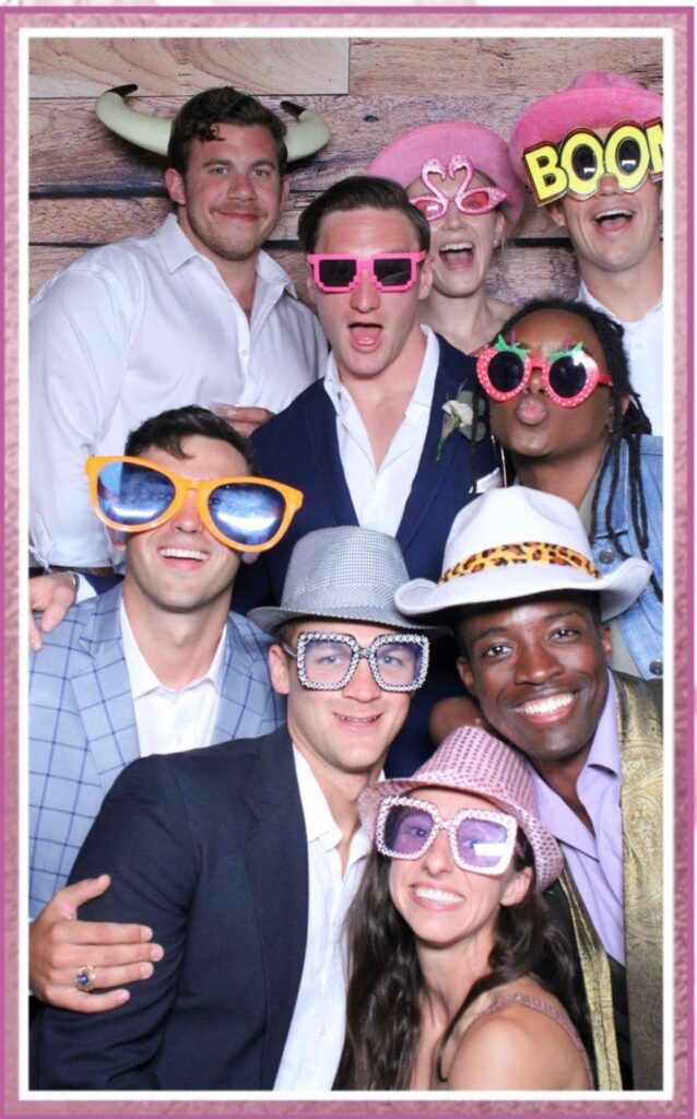 party guests posing with props for photo booth
