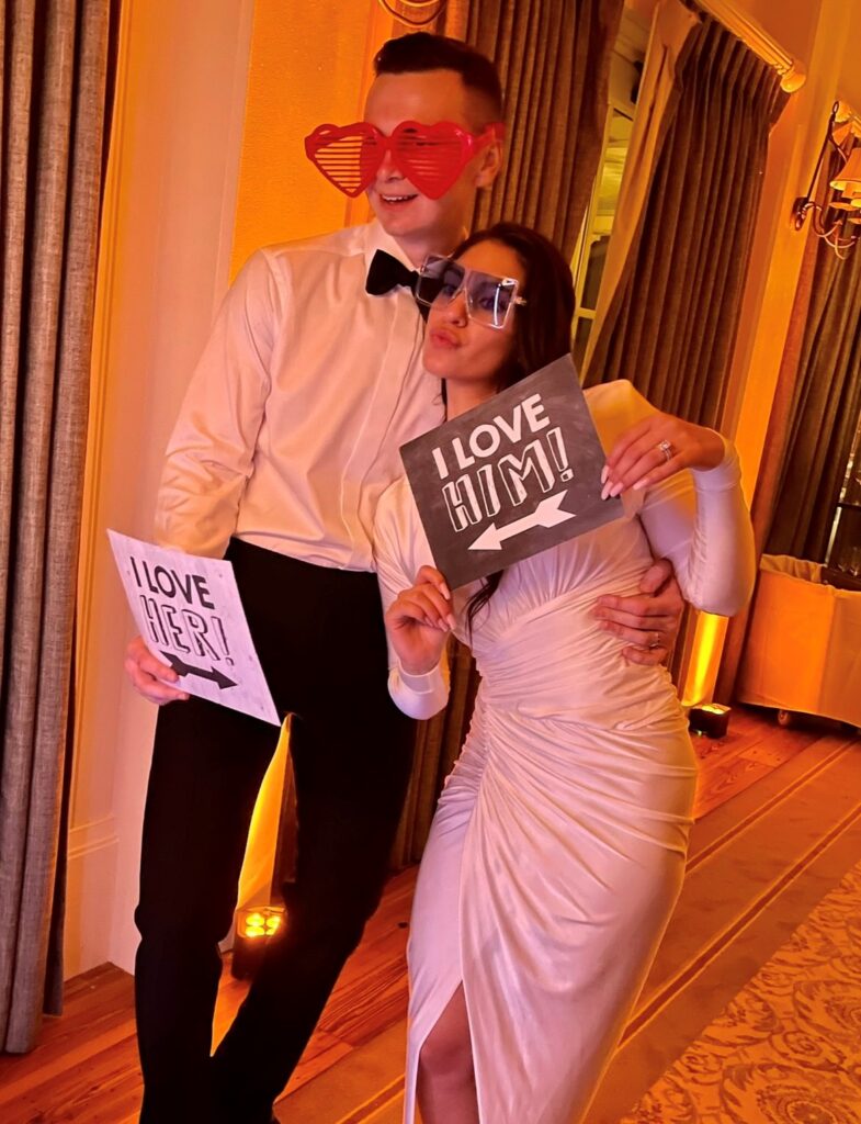 bride and groom posing with props