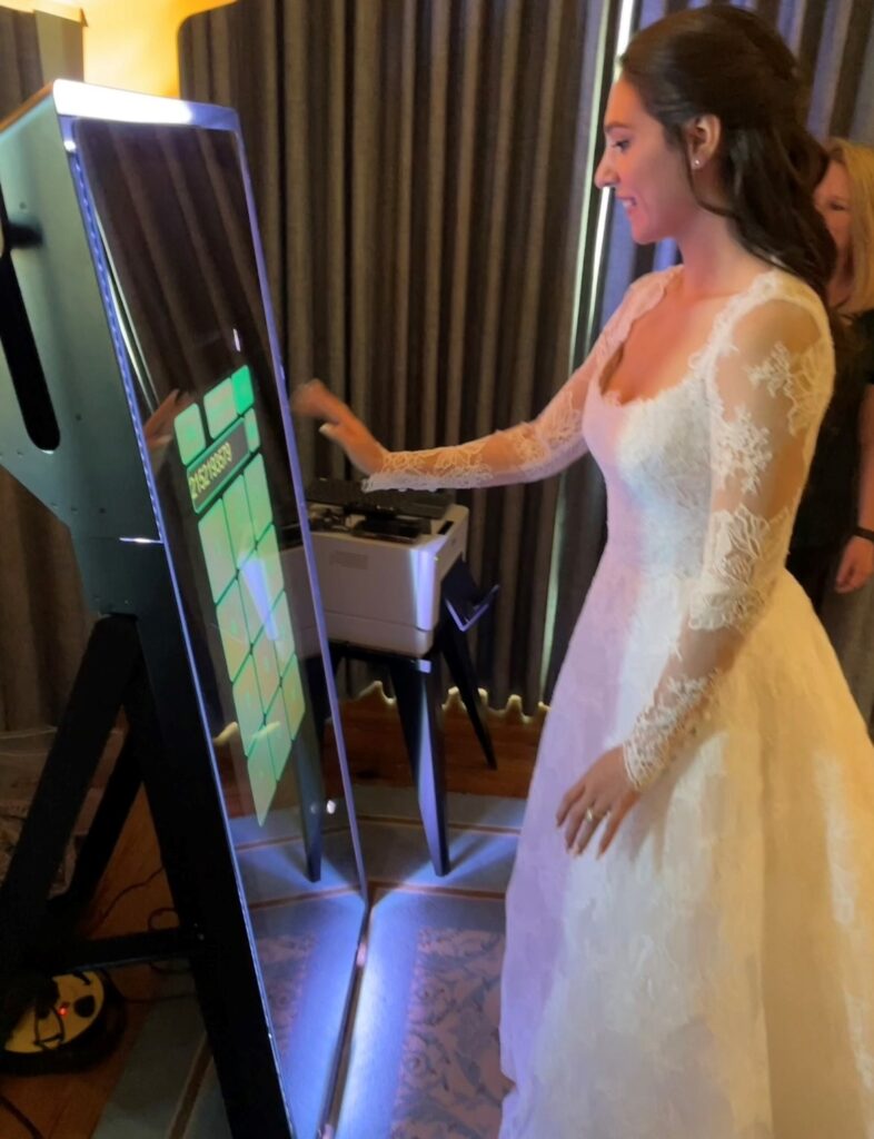 bride using mirror photo booth